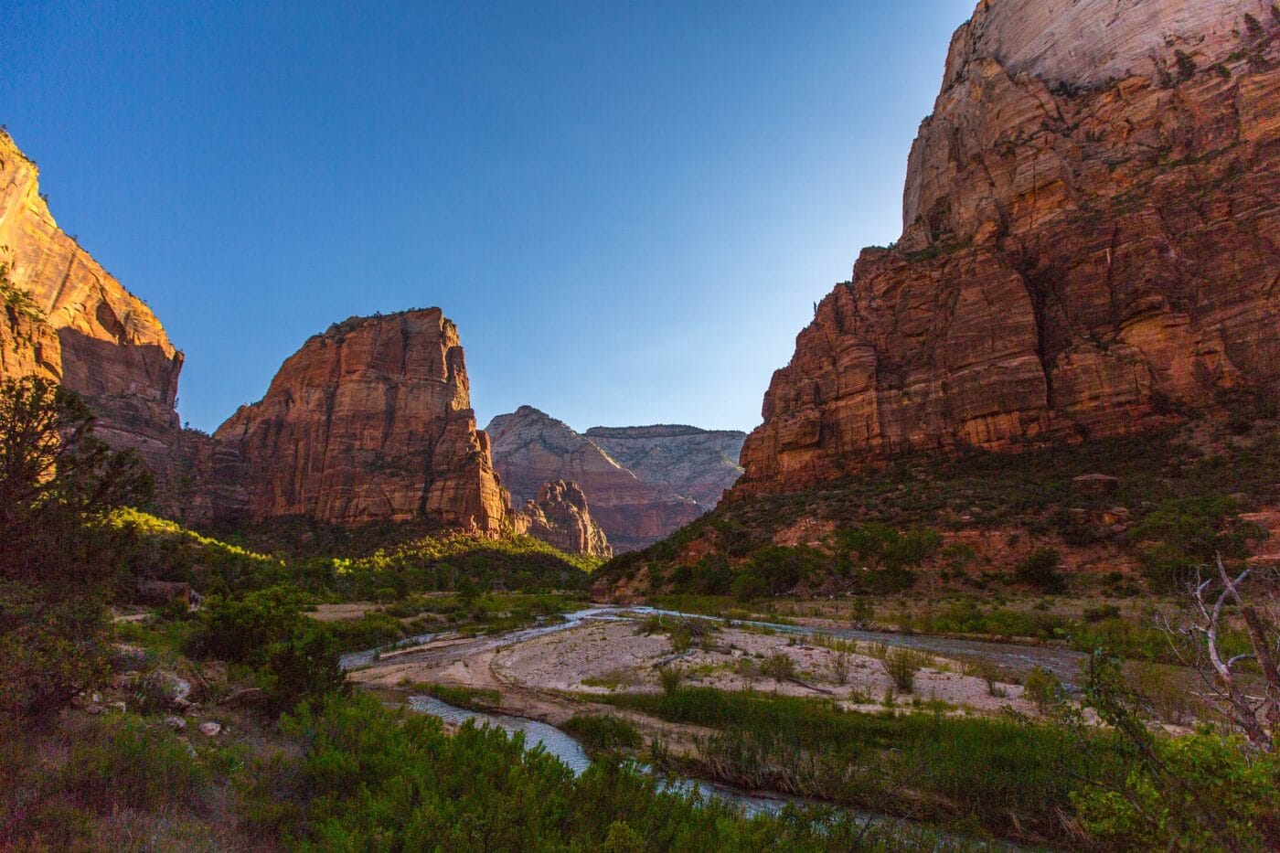 A view of a river in a canyon with orange walls