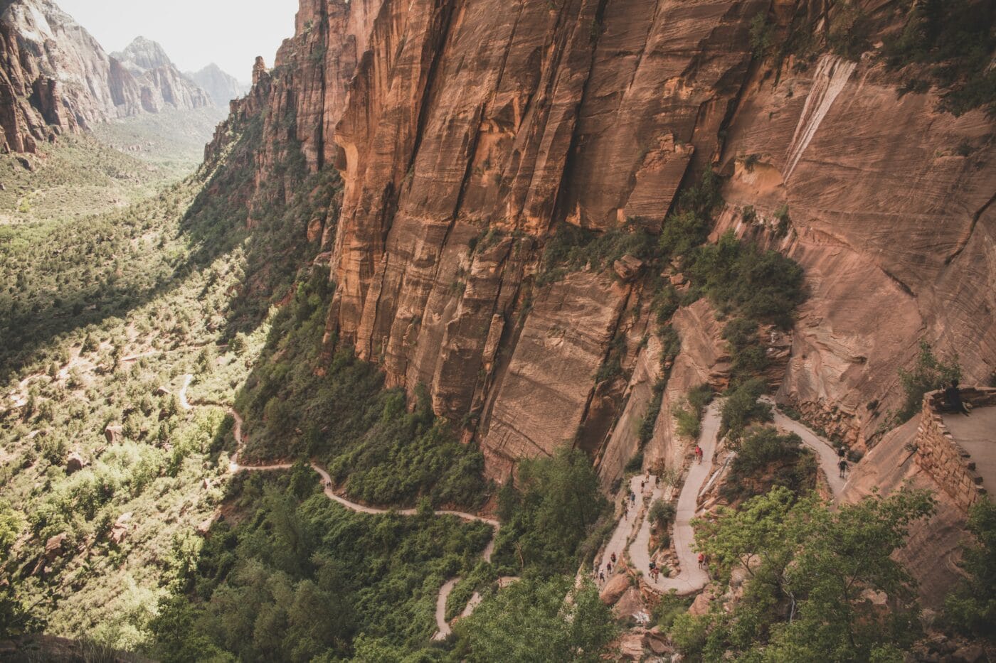 A trail switchbacks along a tall canyon wall