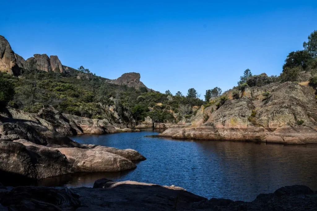 A picture of a lake surrounded by rocky outcropping in Pinnacles National Park