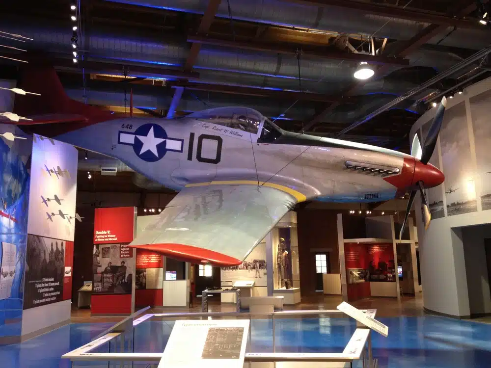 A Tuskegee airplane hanging in a musuem
