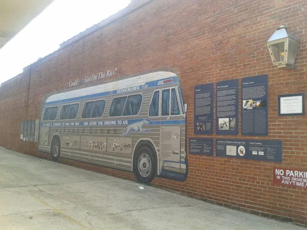 A mural of a greyhound bus on a brick wall