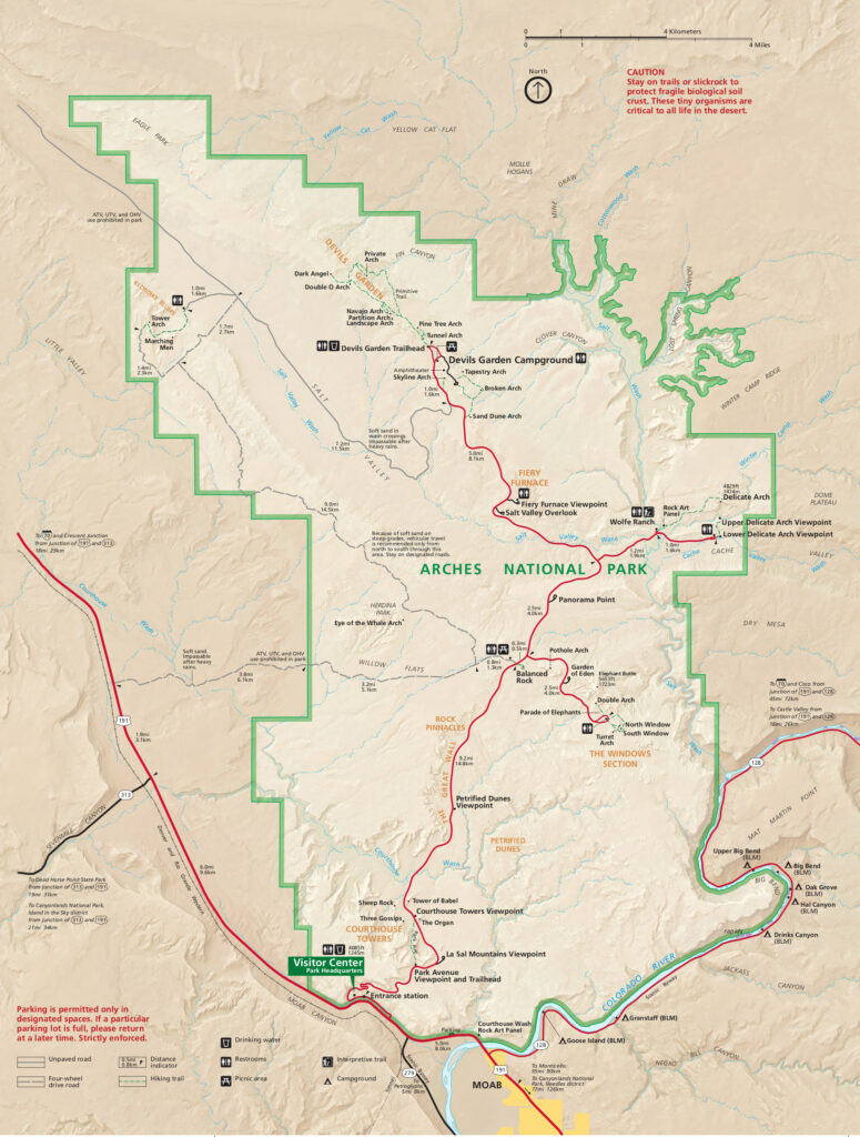 A detailed map of Arches National Park, highlighting key features like Delicate Arch, Devils Garden Campground, and various rock formations. The map includes trails, viewpoints, and the park visitor center near the entrance from Moab.