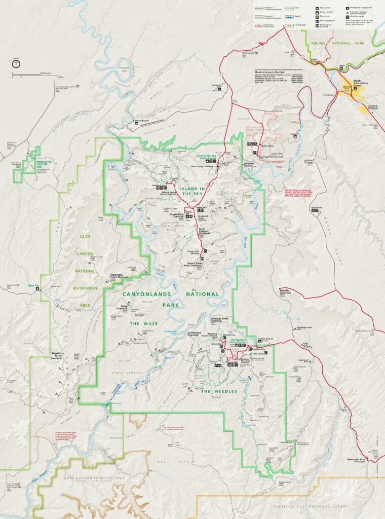 The map of Canyonlands National Park shows distinct regions like Island in the Sky, The Maze, and The Needles. It details roads, trails, campgrounds, and visitor centers within the park boundaries and adjacent areas.