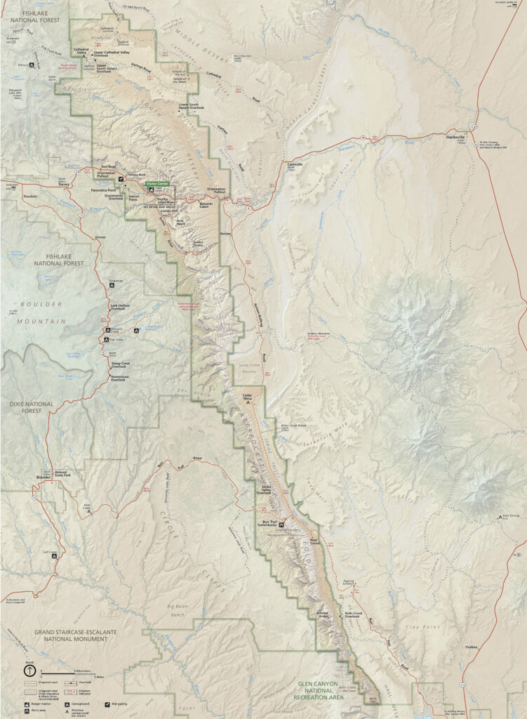 This map highlights Capitol Reef National Park, featuring the Waterpocket Fold, major trails, campgrounds, and visitor centers. The map also includes surrounding areas such as Fishlake National Forest and Grand Staircase-Escalante National Monument.