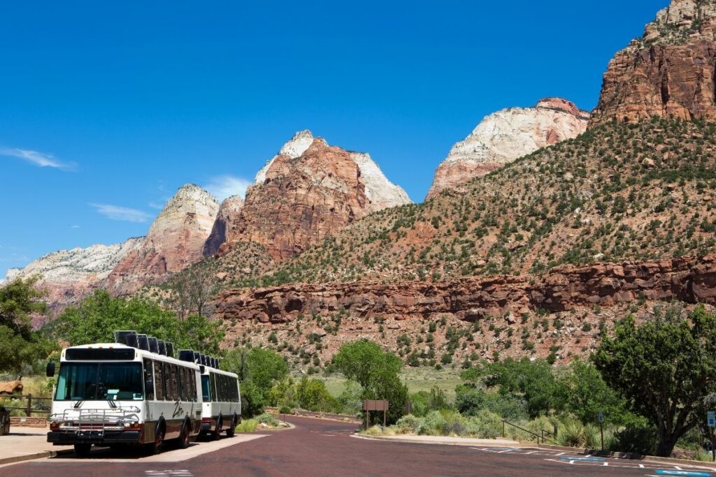 Zion Shuttle stopped at the Zion Shuttle Stop look out on the towering cliff walls.  