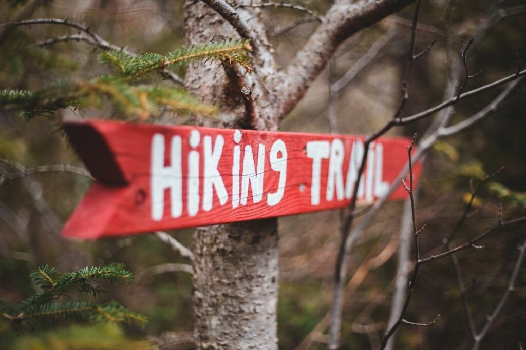 Red sign that says Hiking Trail