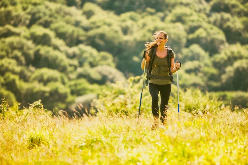 A woman hiking through a field of glass.