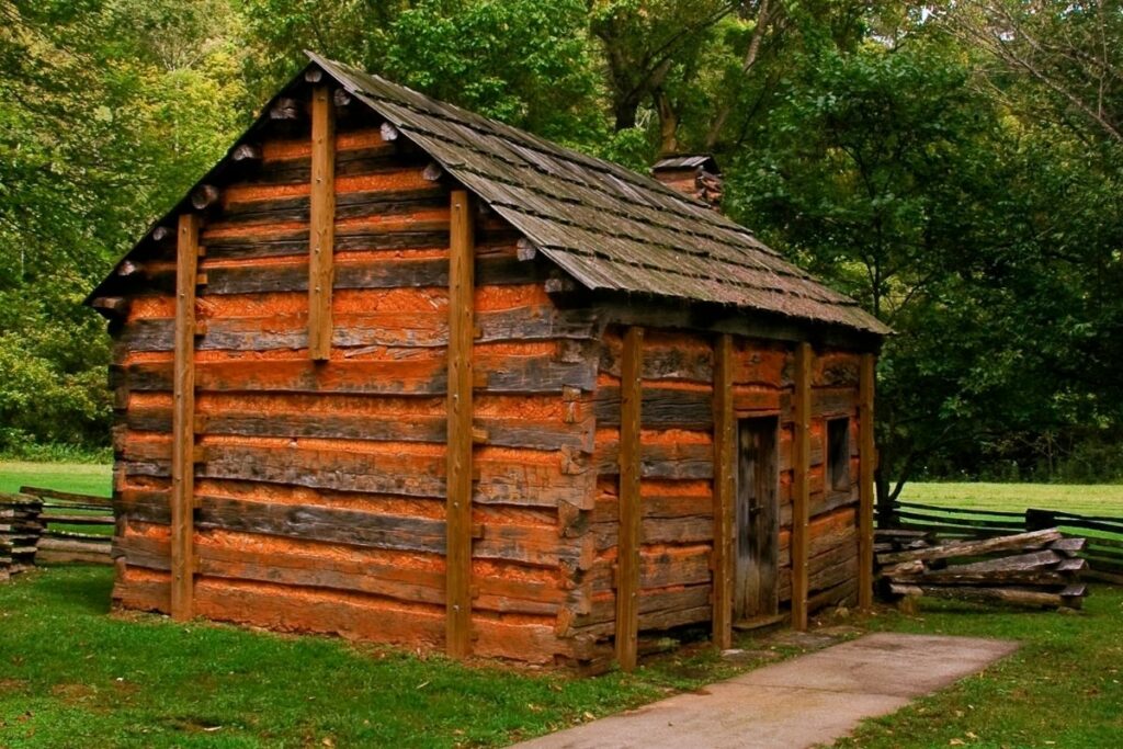 A log cabin in a field