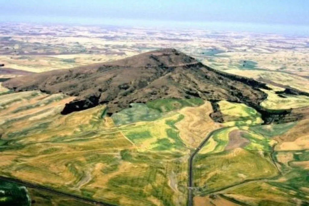 A bird's eye view of a mountain and fields