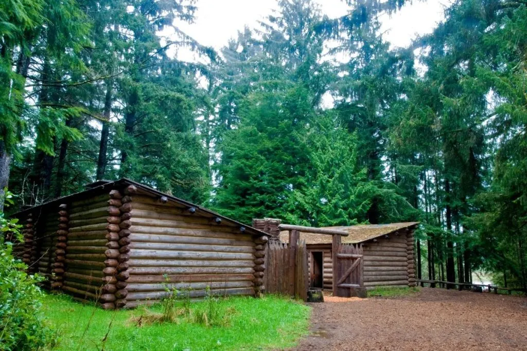 Two log cabin with a wood entrance gate