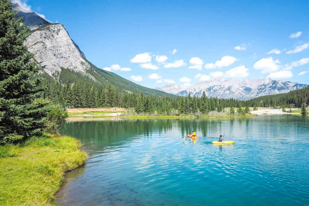 Two kayakers on a blue mountain lake