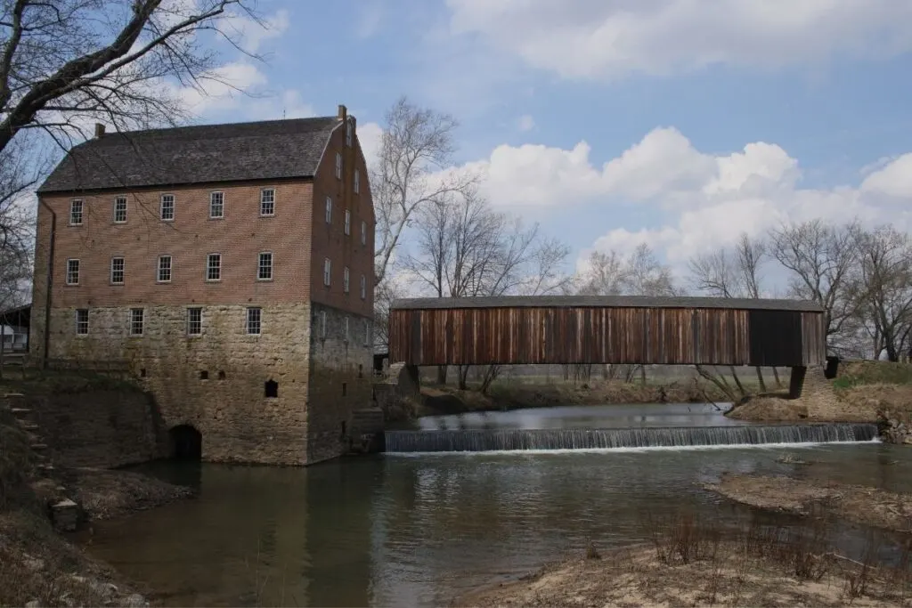 A brick mill located on a river.