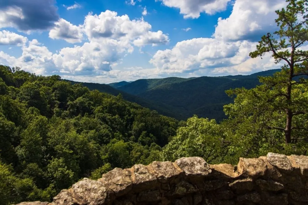Looking out over a stone wall to the rolling forests and mountains of Shenanodah. 