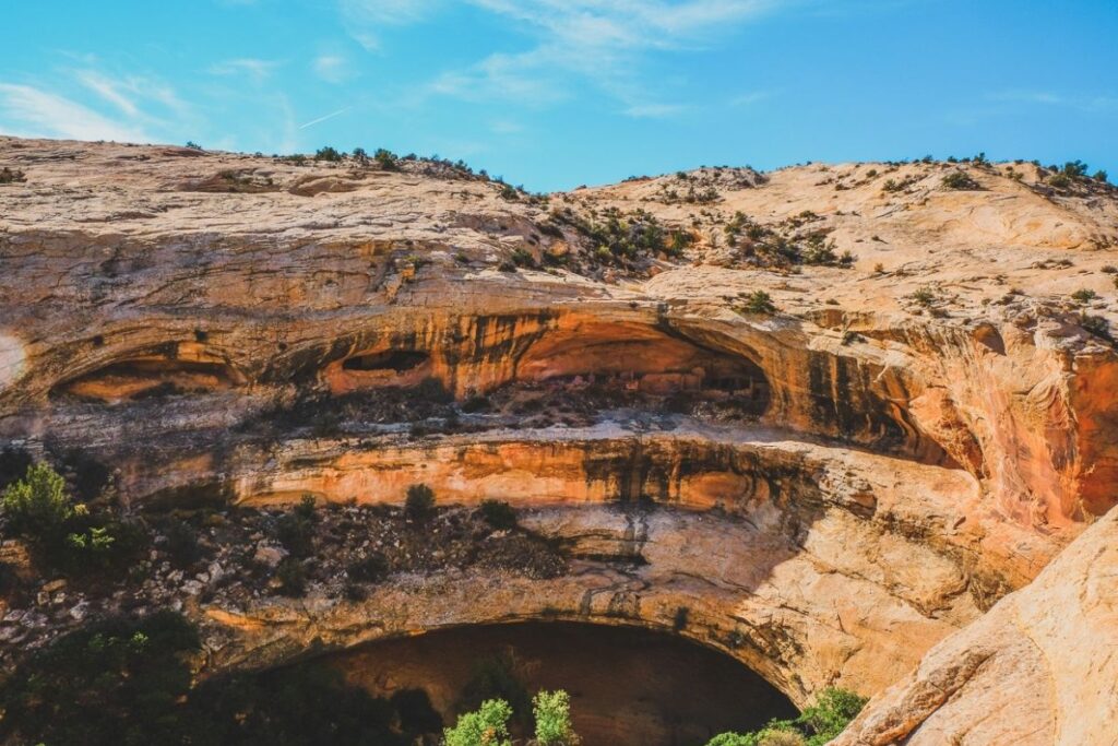 A circular spot in a cliff with cliffing dwellings