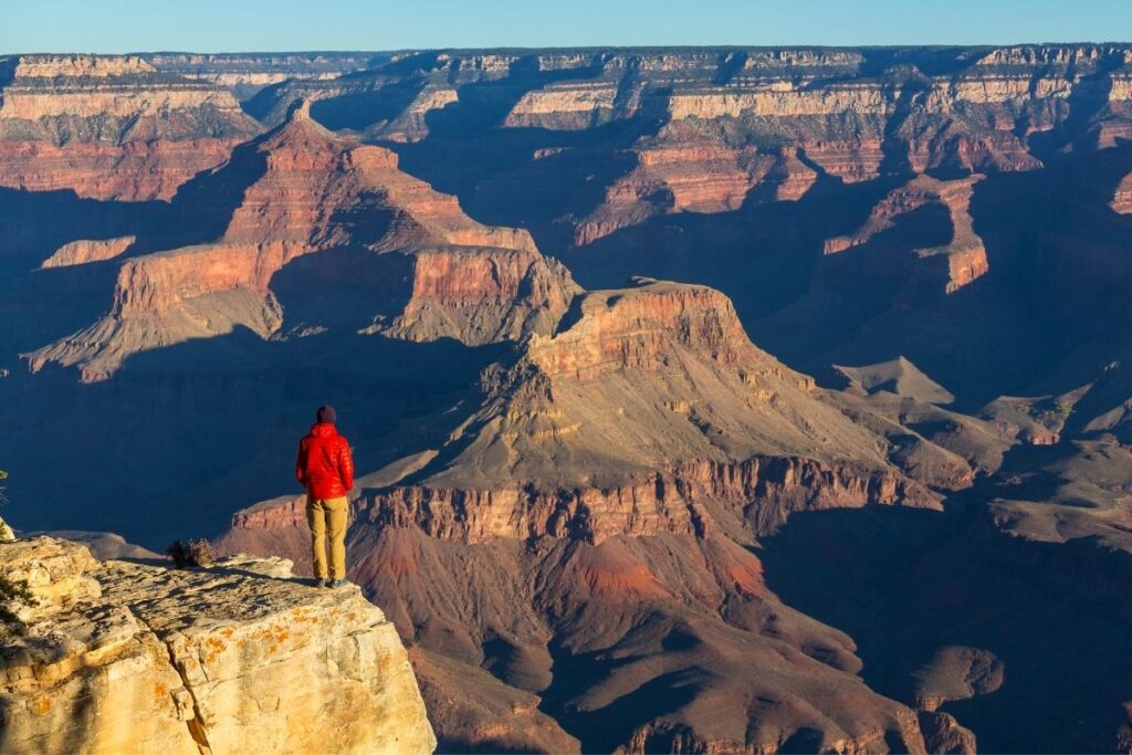 A hiker looks out over the Grand Canyon