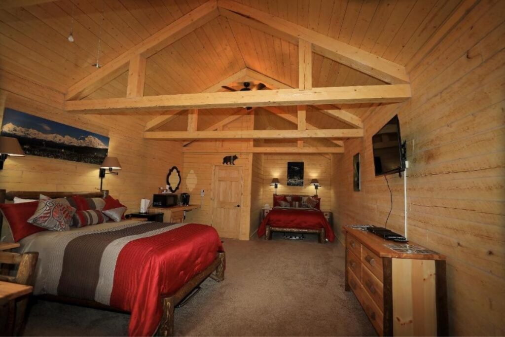 the interior of a log cabin with two beds
