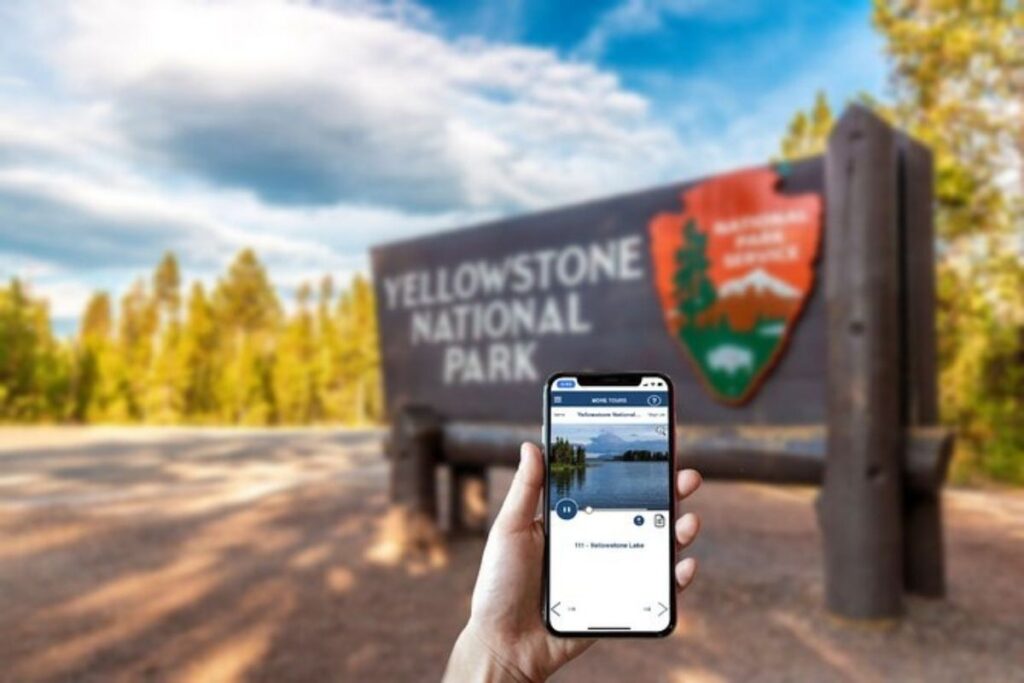 a phone in the front of the Yellowstone park sign