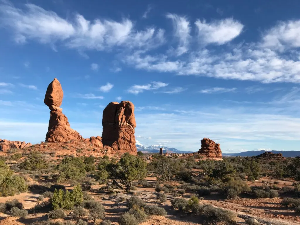 A tall rock formation that looks like its carefully balanced.  