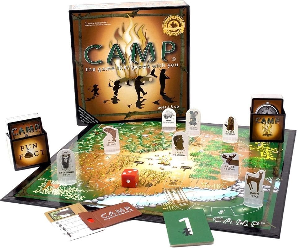 'CAMP' board game set up with cards, pieces shaped like forest animals, and trivia about national parks.