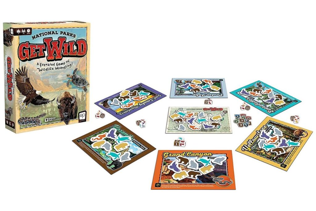 National Parks 'Get Wild' board game spread out with box, cards, and puzzle pieces showcasing wildlife themes.