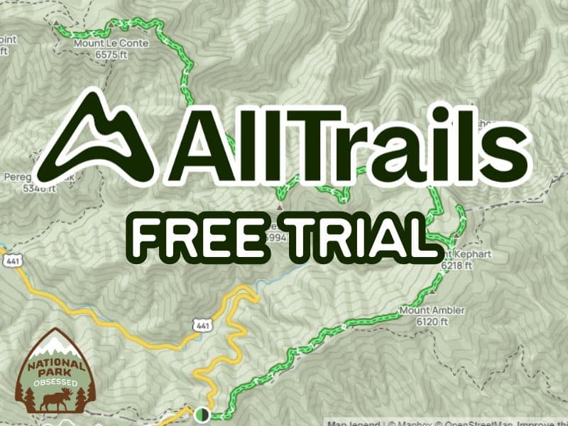 This image features a promotional graphic for AllTrails with the text "AllTrails FREE TRIAL" superimposed over a topographic map background showing various hiking trails and elevation markers. The AllTrails logo is prominent in the center, and there's a badge for "National Park Obsessed" at the bottom left corner. The map details include named locations like Mount Le Conte and Mount Ambler.