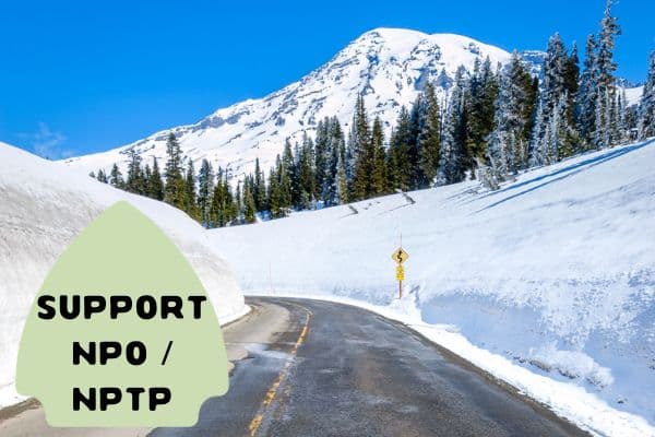 A snow-covered mountain road leading to a peak under a clear blue sky, with text "Support NPO / NPTP" in a green badge on the left side.
