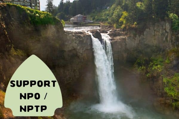 A stunning waterfall cascades over a rocky cliff surrounded by lush greenery, with a sign in the foreground that reads "SUPPORT NPO / NPTP" on a green, arrow-shaped background.