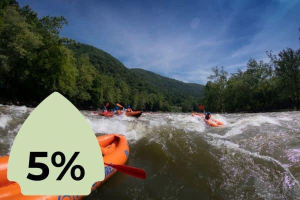 Several orange rafts in a river, battling waves with a forested hillside in the background. A green icon with "5%" is superimposed on the left side.