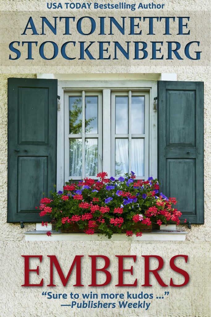 Book cover of "Embers" by Antoinette Stockenberg, identified as a "USA Today Bestselling Author." A white framed window with dark green shutters and a flower box overflowing with pink, red, and purple blossoms fills the cover, with the title in large red letters and a quote from Publishers Weekly reading "Sure to win more kudos ..."